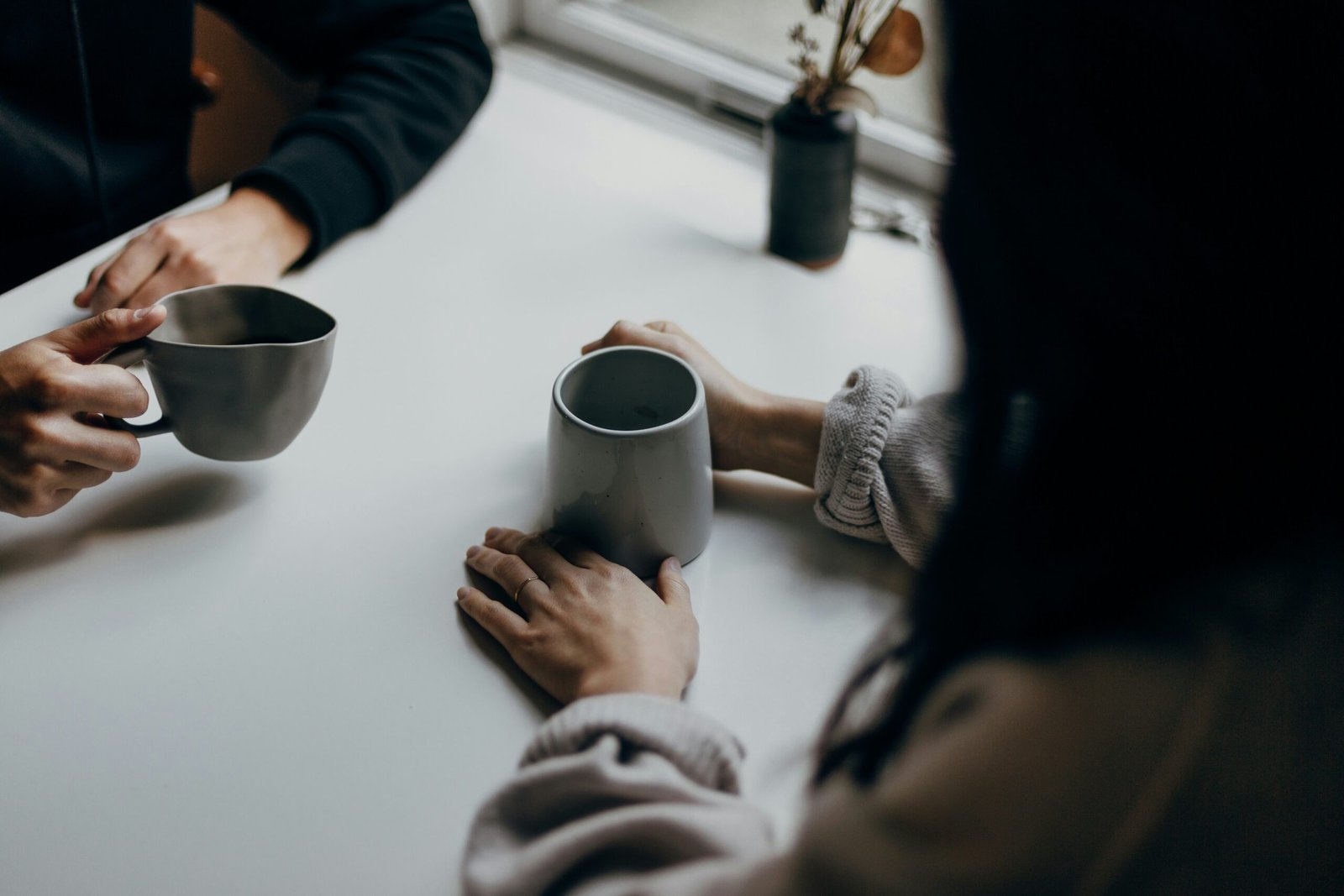 Two people holding hands in a moment of comfort and support